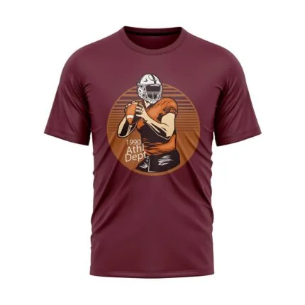Maroon short-sleeve T-shirt featuring a circular graphic of an American football player holding a football with "1990 Athl. Dept." text, front view