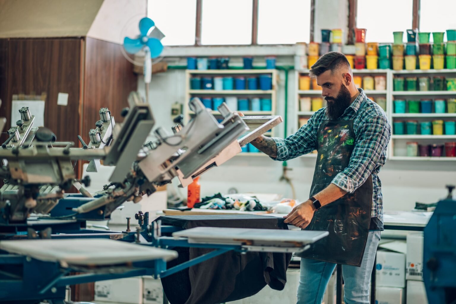 male-worker-using-printing-machine-in-a-workshop-2026-03-25-00-01-13-utc